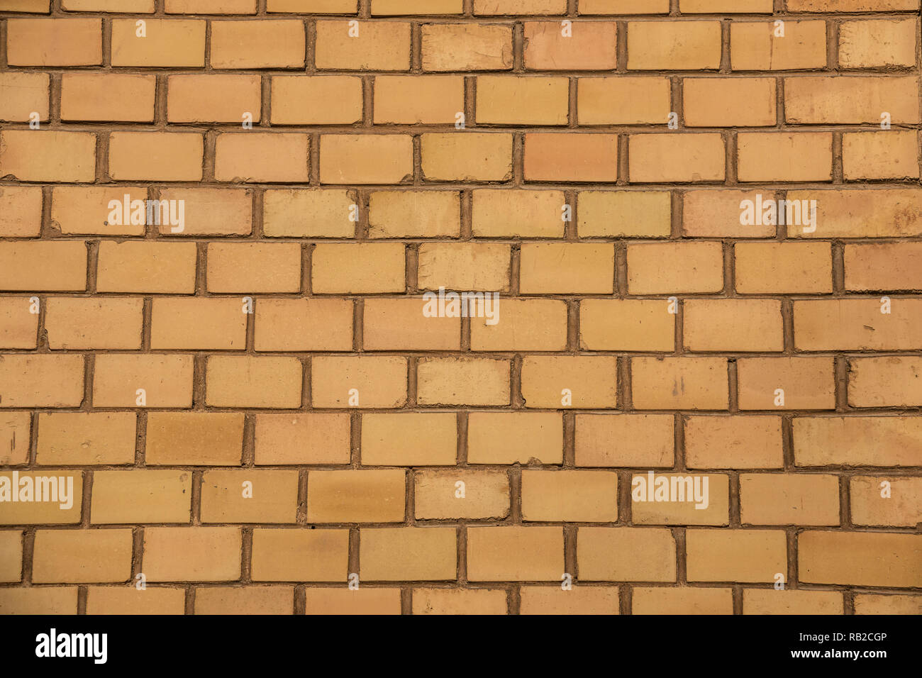 Old empty brick house factory wall with yellow bricks Stock Photo