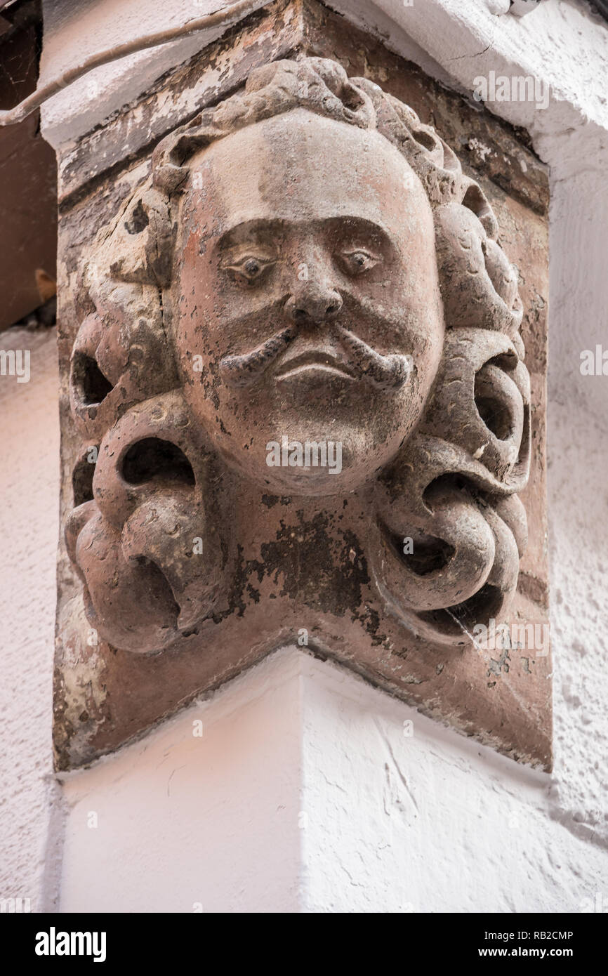 Stone head on the corner of an old building Stock Photo