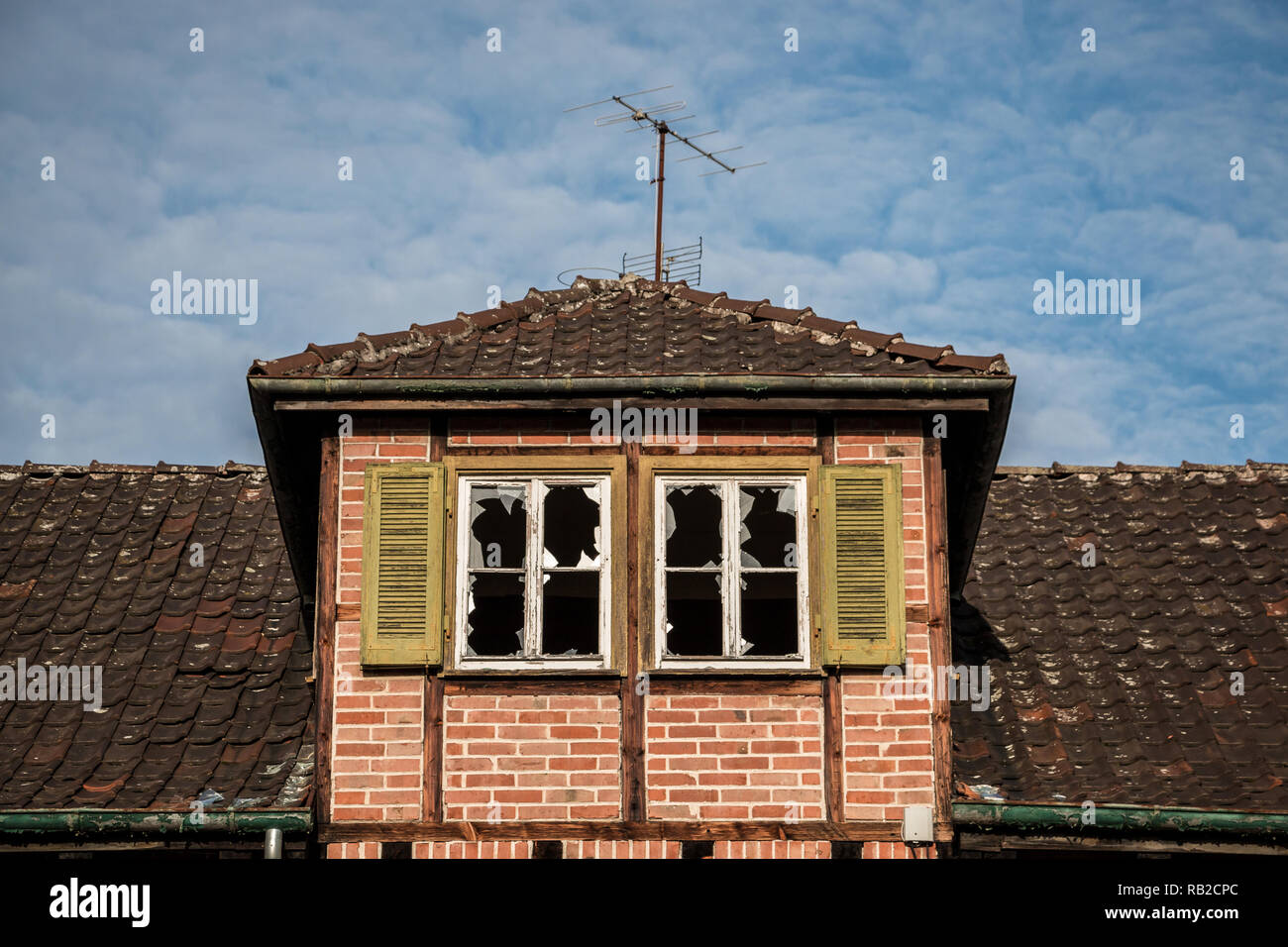 Old destroyed brick house ruin with broken windows Stock Photo