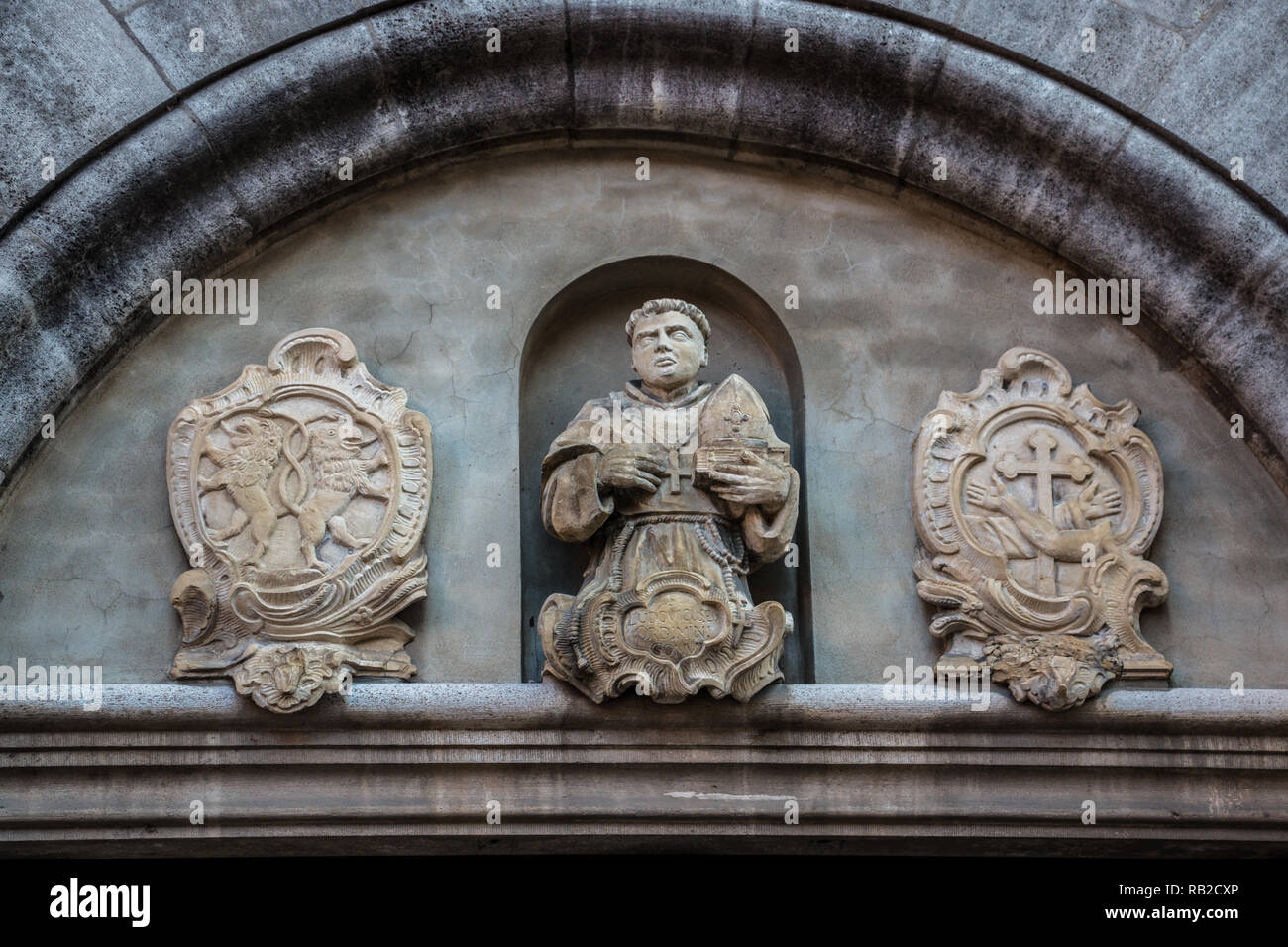 Beautiful coat of arms and statue on a historical old building Stock Photo
