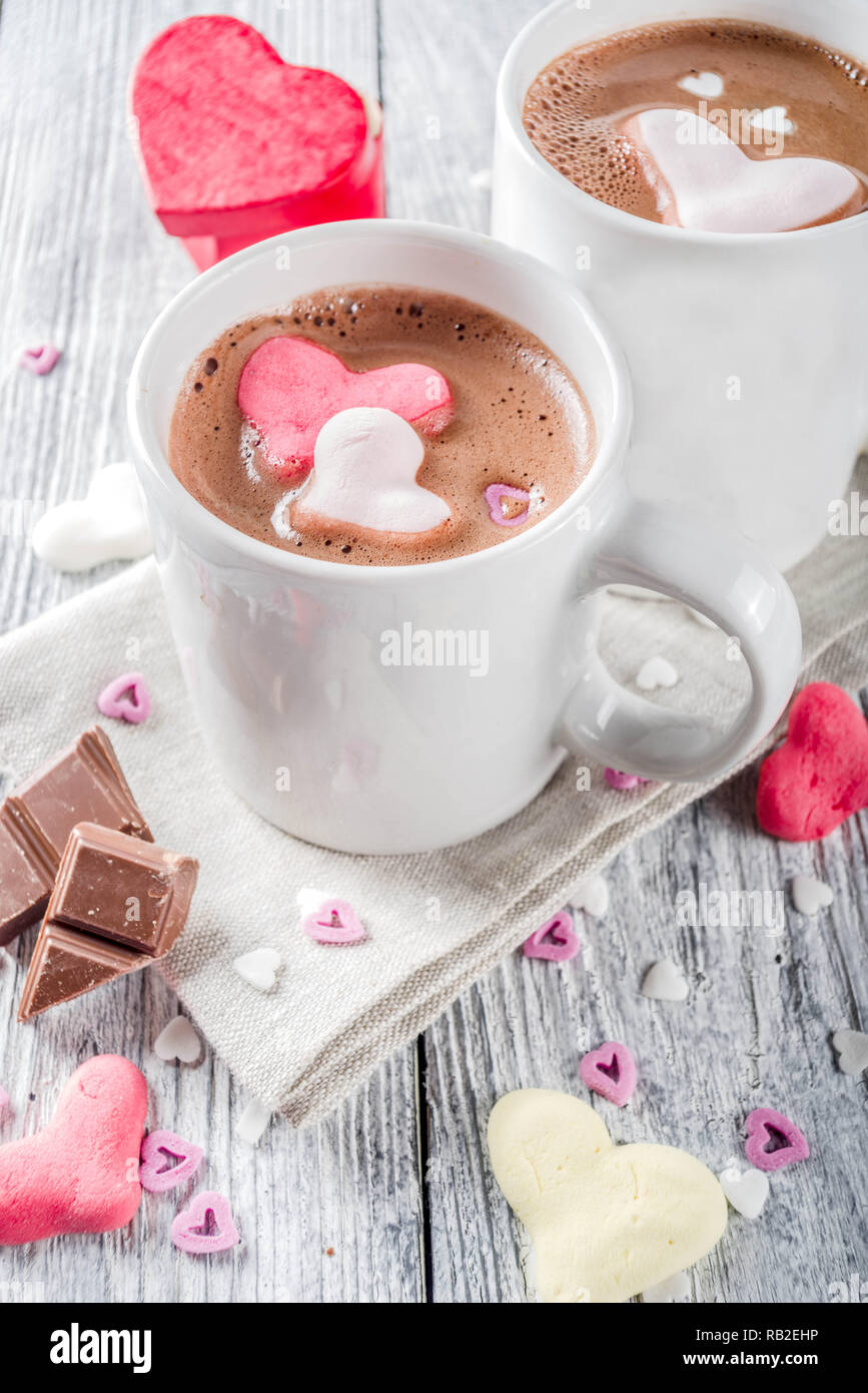 https://c8.alamy.com/comp/RB2EHP/valentines-day-treat-ideas-two-cups-hot-chocolate-drink-with-marshmallow-hearts-red-pink-white-color-with-chocolate-pieces-sugar-sprinkles-old-wood-RB2EHP.jpg
