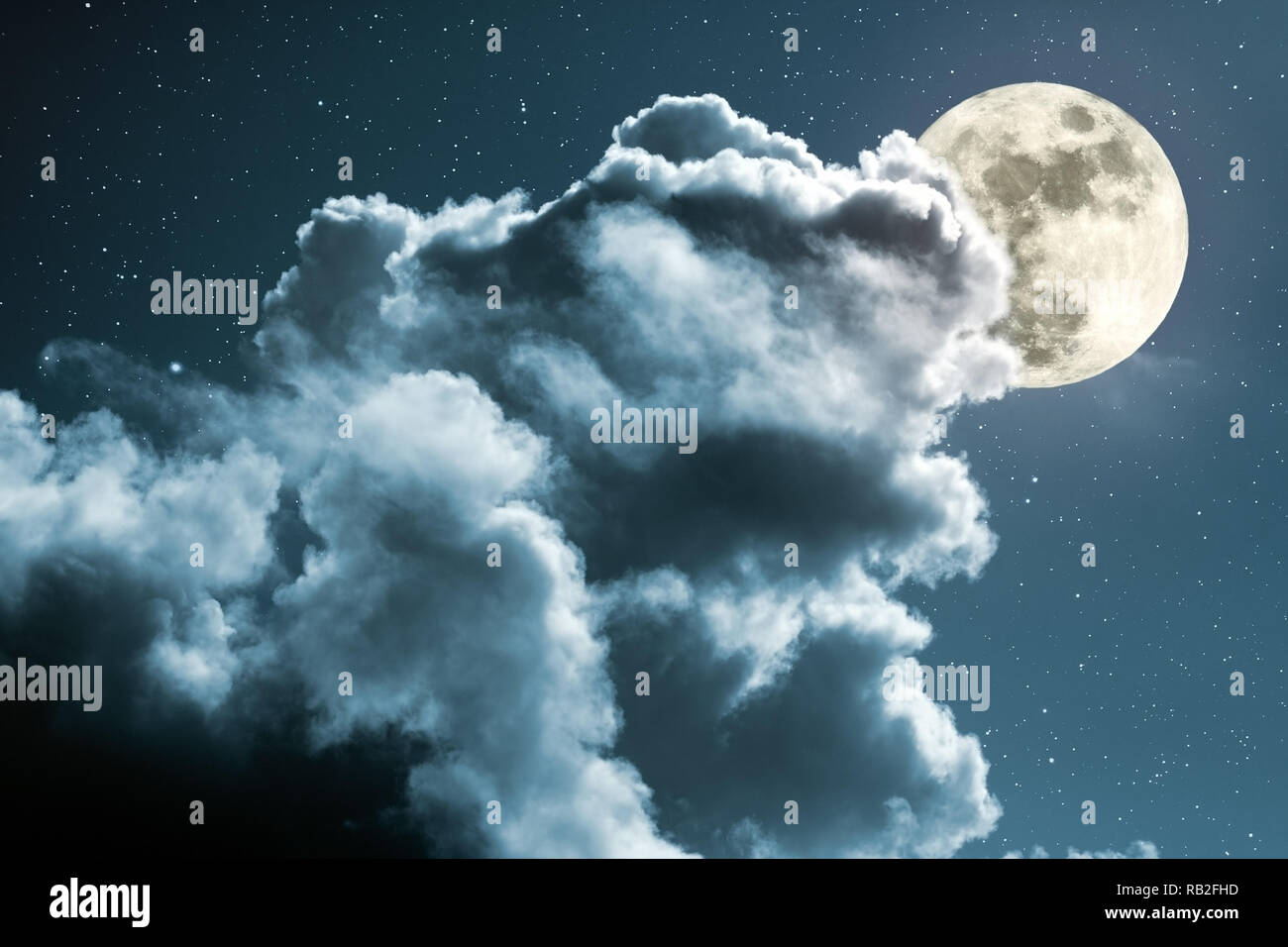 Full moon behind the clouds on a starry night Stock Photo Alamy
