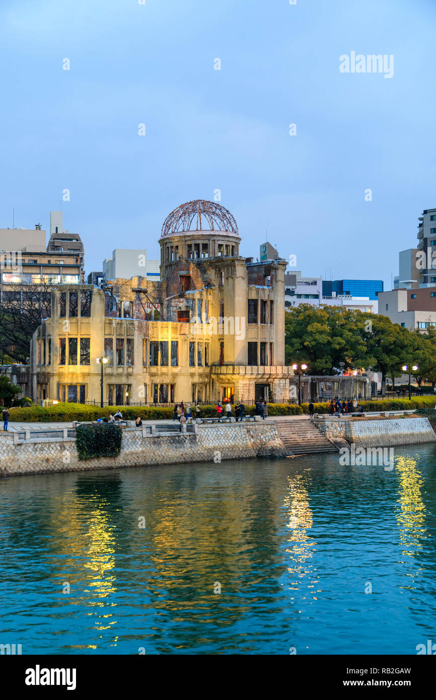 Hiroshima Peace Memorial, the Atomic Bomb Dome, A-Bomb Dome, Genbaku Dome, at early evening with the river reflecting the building and lights. Stock Photo