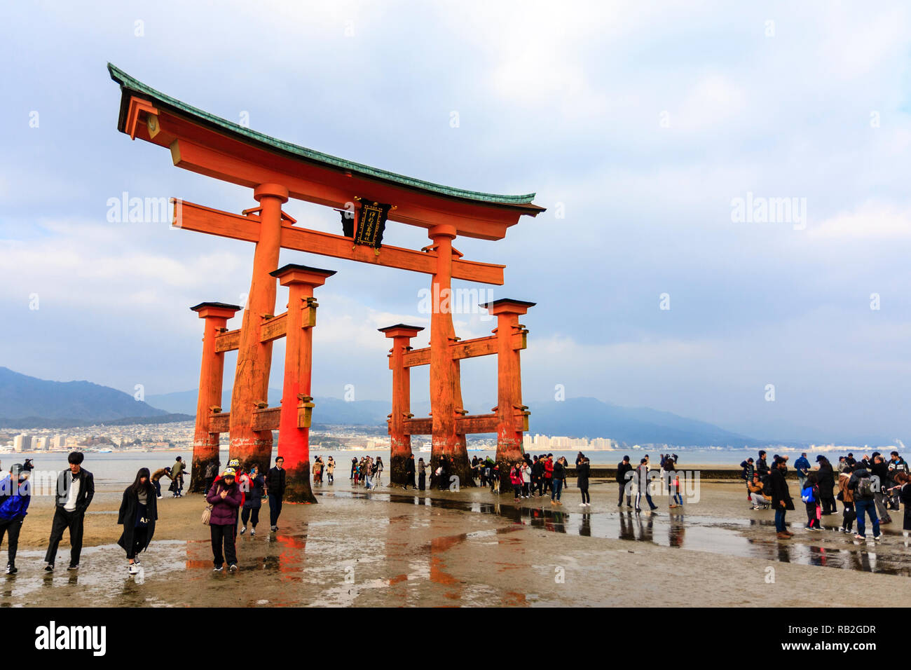 Japan. The Great Torii at the Itsukushima Shinto shrine on Miyajima Island  at low tide with crowds of people around it's base of six pillars Stock  Photo - Alamy