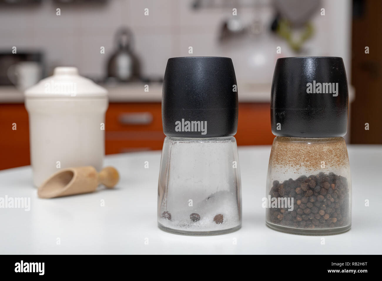 Salt And Pepper In Containers On The Kitchen Table Spices In The