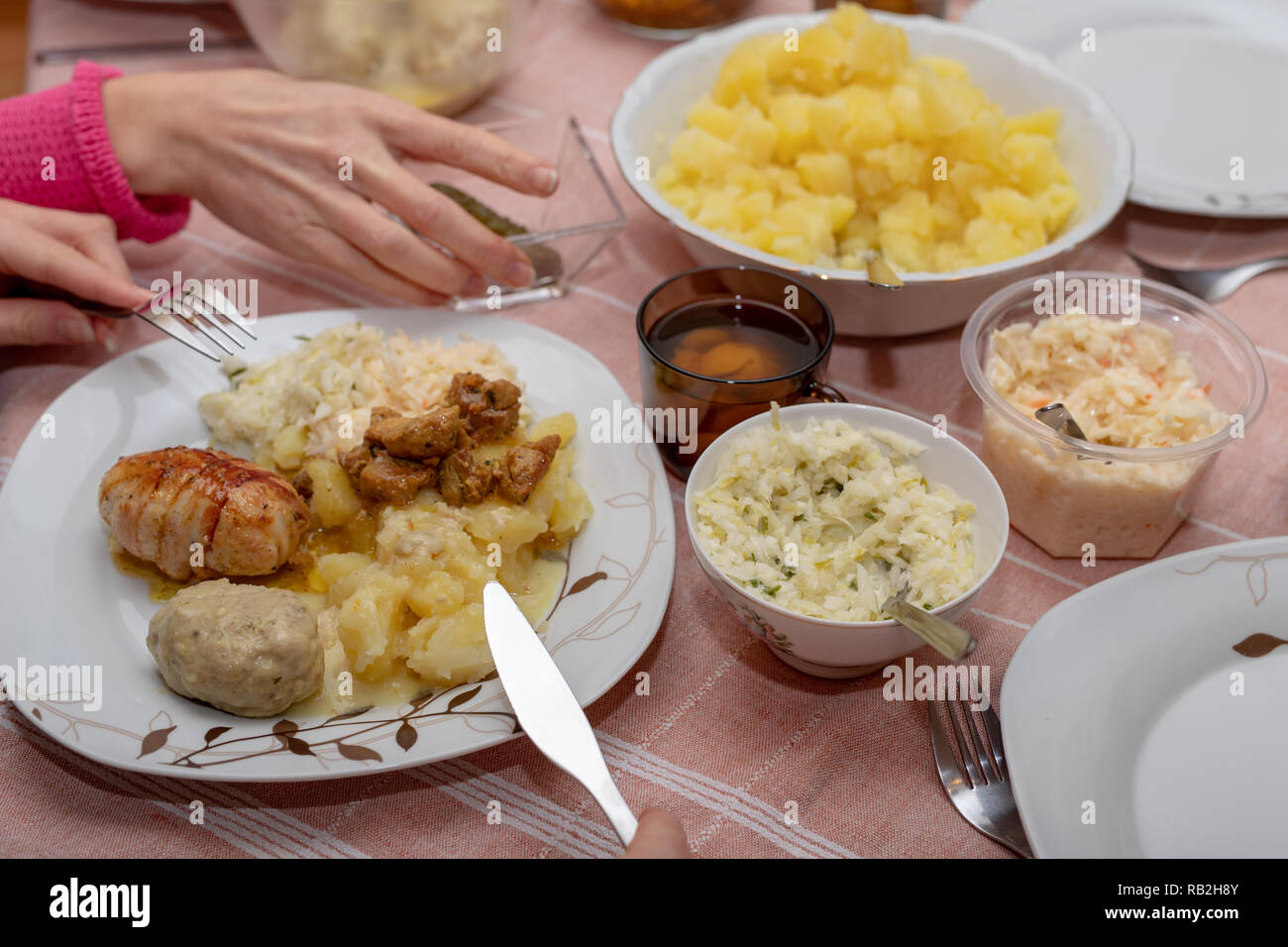 Dishes prepared for a homemade dinner. Family meeting at the kitchen table. Light background. Stock Photo