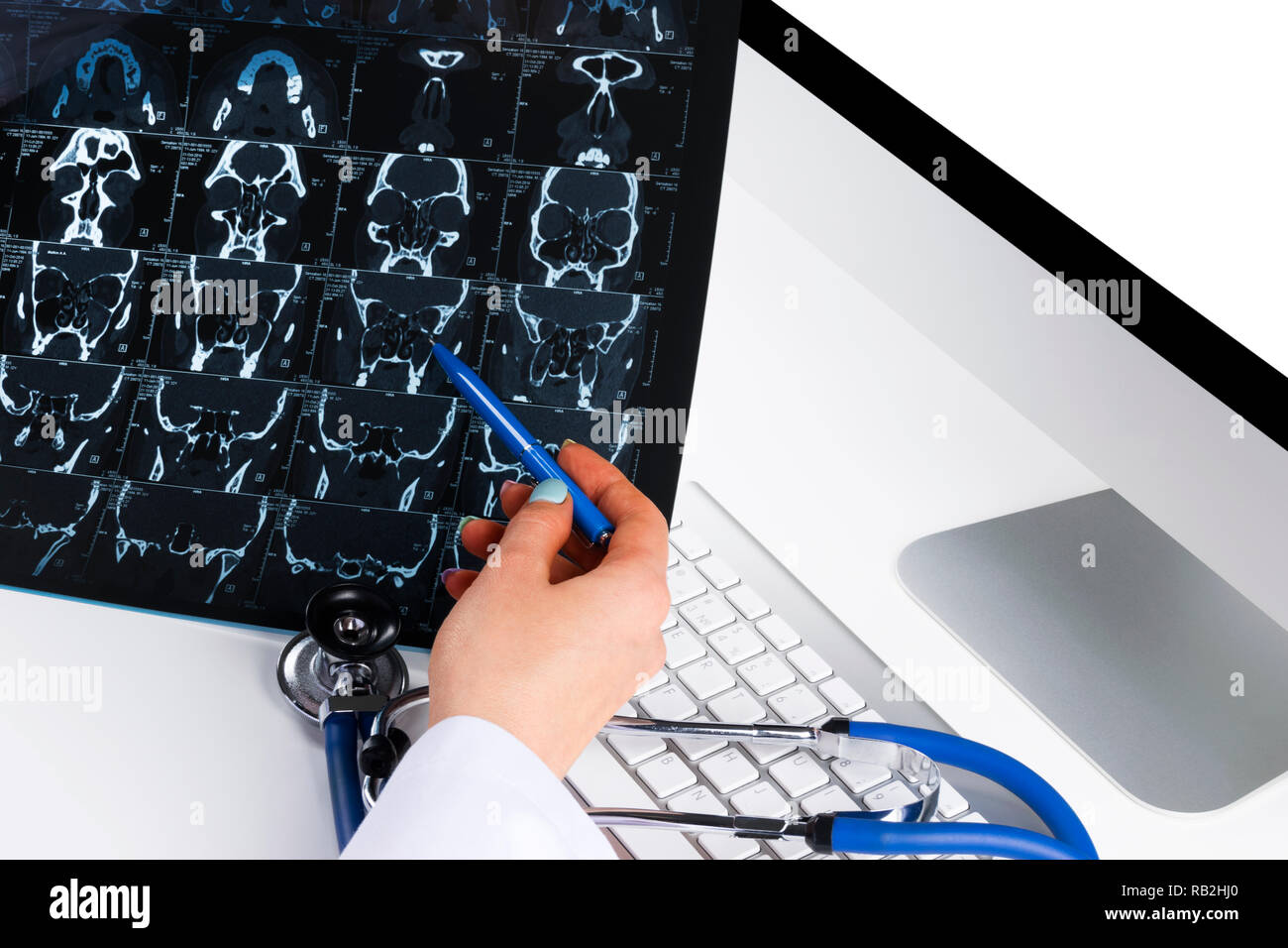 Doctor looking at computer tomography x-ray image, medicine doctor's working table with computer and stethoscope. Healthcare concept Stock Photo