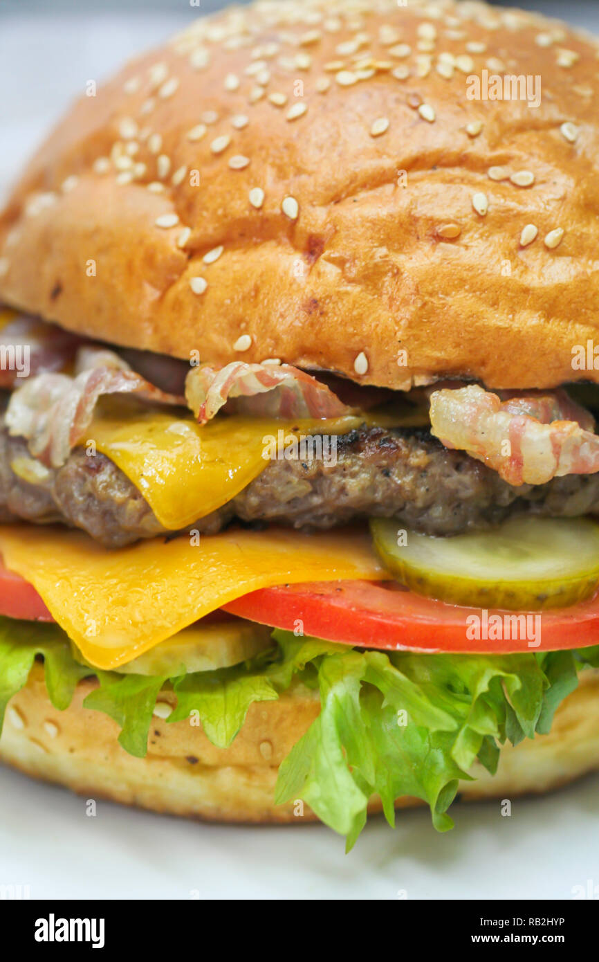 Close up of freshly cooked burger with ground beef and bacon, cheddar