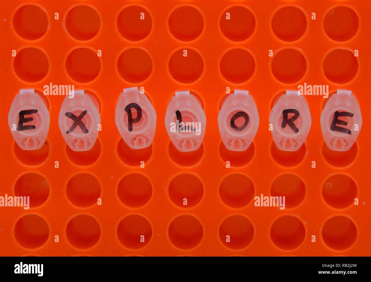 Test tube in an orange colored laboratory rack - looking from above Stock Photo