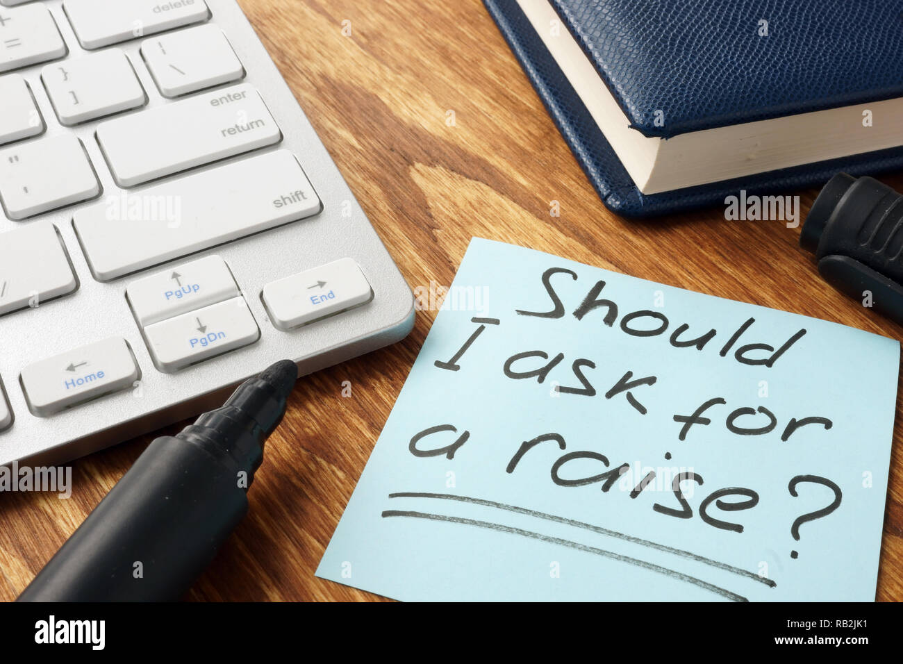 Should I ask for a raise. Office desk with papers. Career concept. Stock Photo