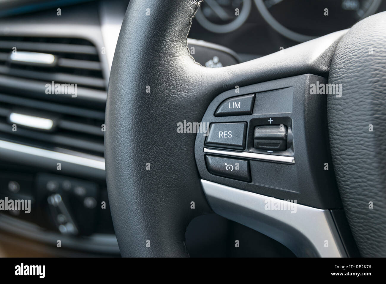 cruise control buttons on the steering wheel of a modern car, car