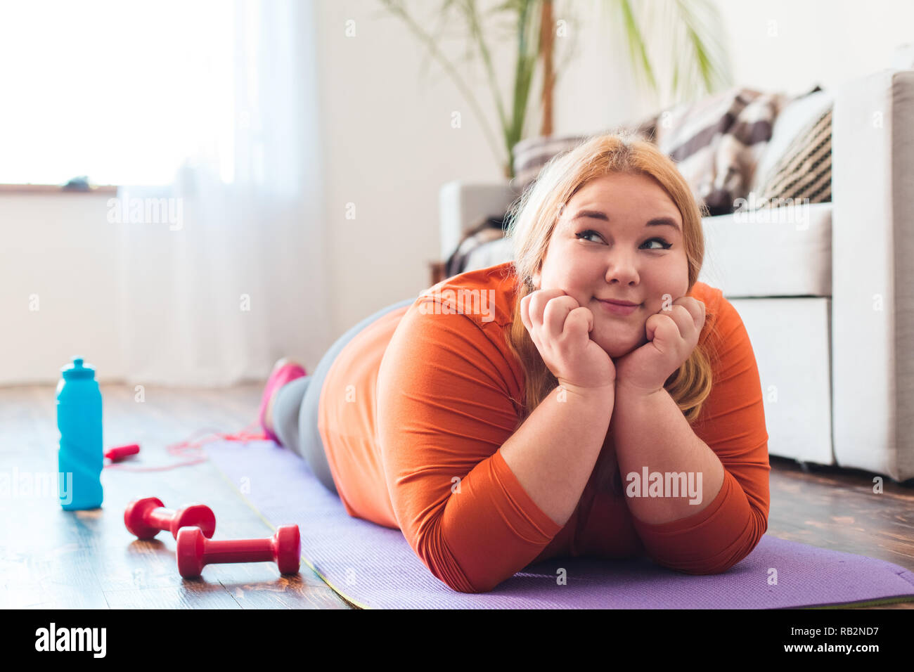 chubby-woman-sport-at-home-lying-on-mat-dreaming-happy-stock-photo-alamy