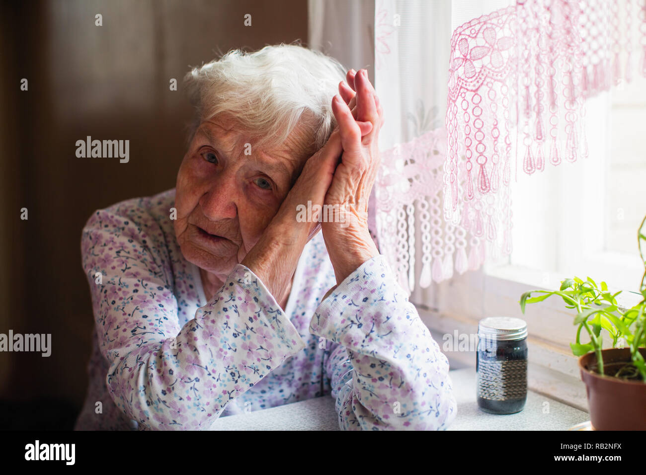 Old women sitting bed sad hi-res stock photography and images - Alamy