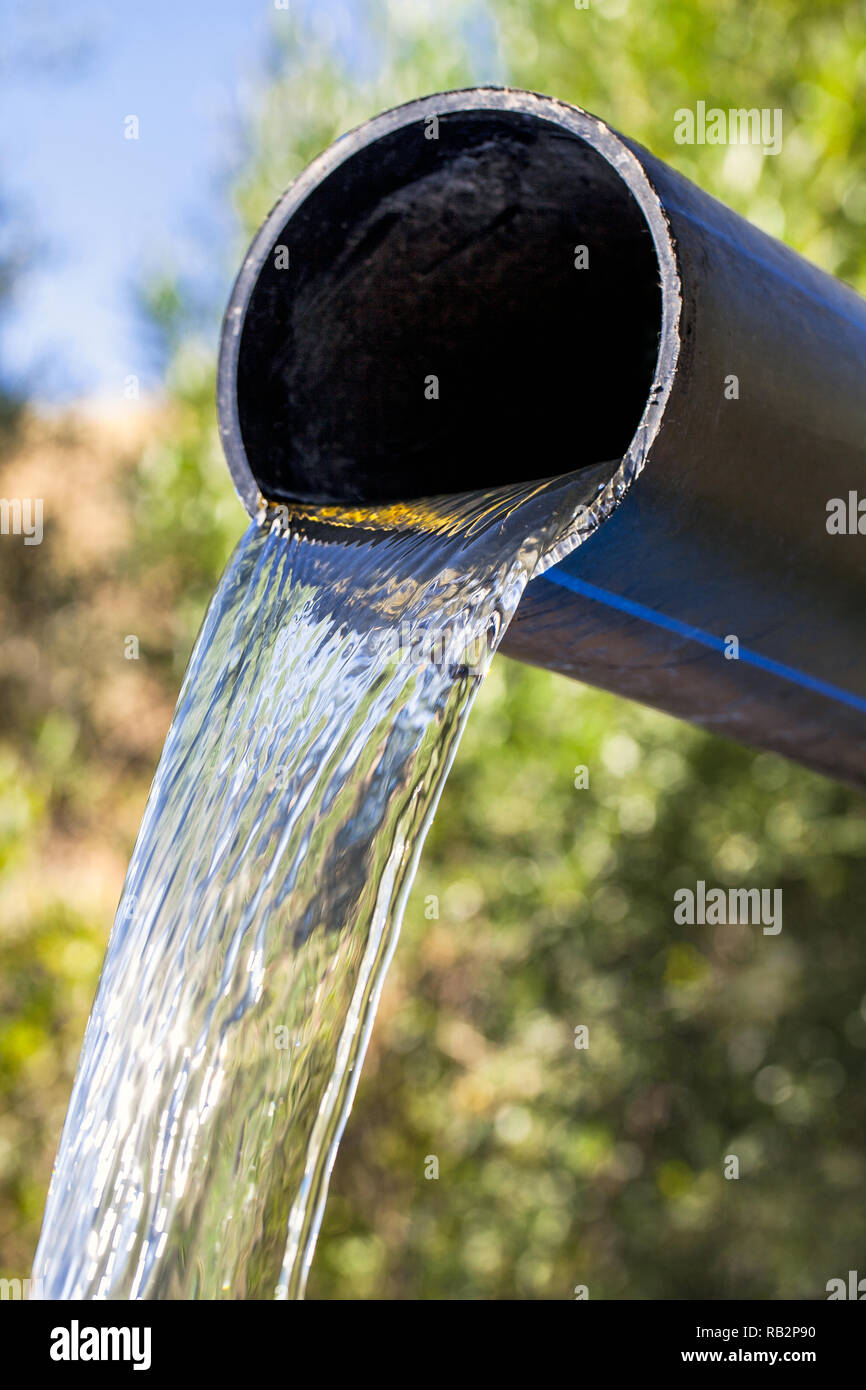 Clean water coming out of an big pipe Stock Photo