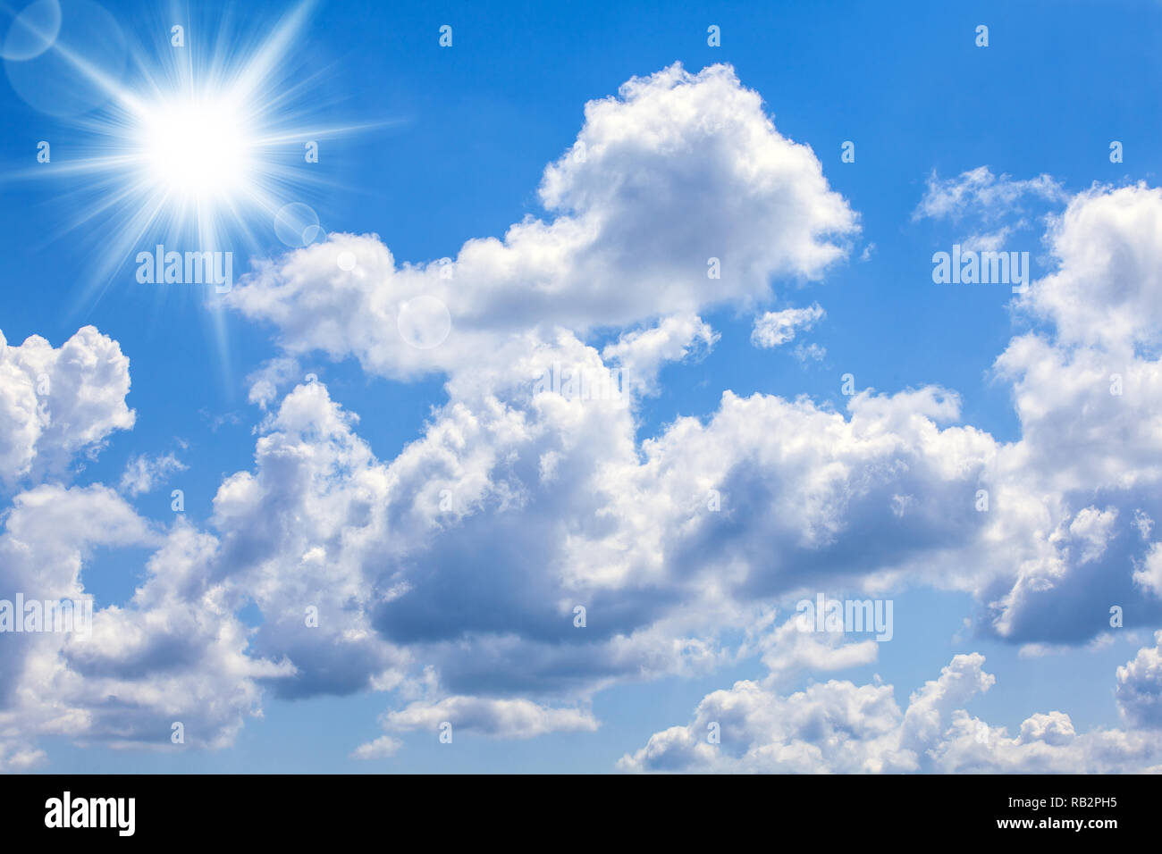A blue sky with bright sun and clouds. Stock Photo