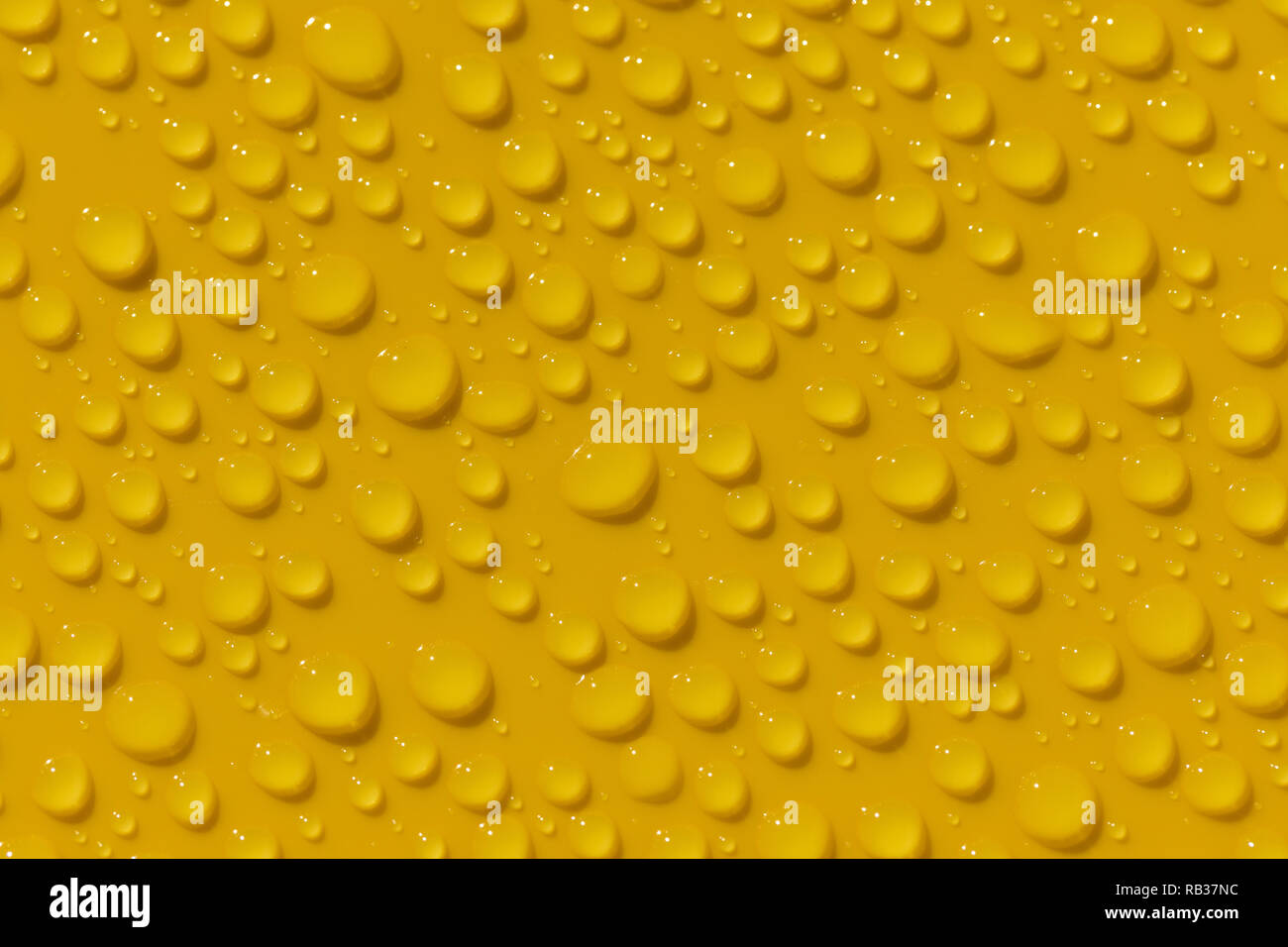 Morning dew on yellow plastic surface Stock Photo