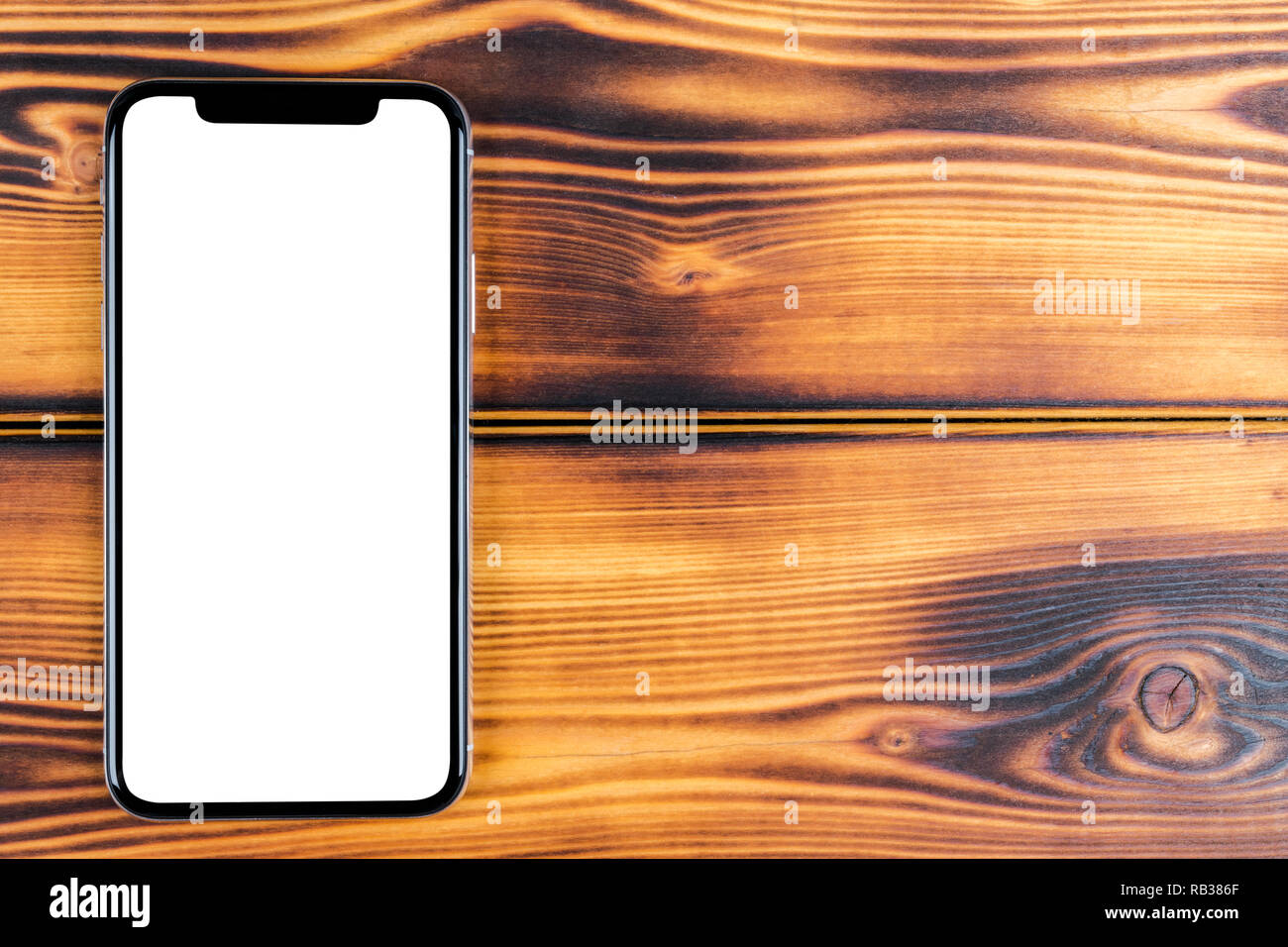 Frameless mockup smartphone with blank screen on office desk. Isolated ...