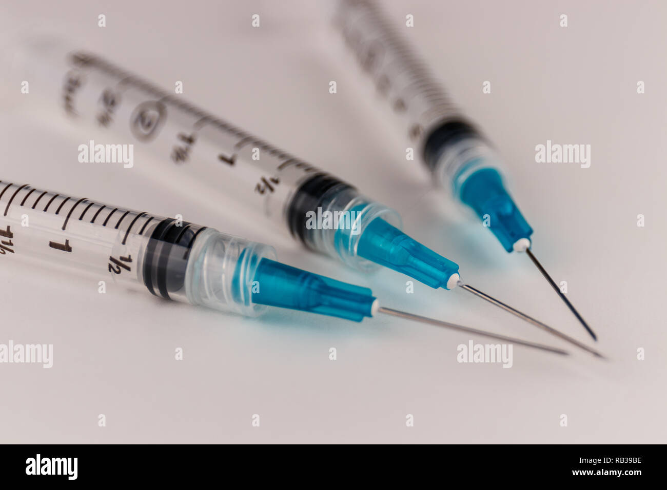 Close up view of a three syringes with hypodermic needles. Opiate and heroin overdoses have skyrocketed in recent years VI Stock Photo