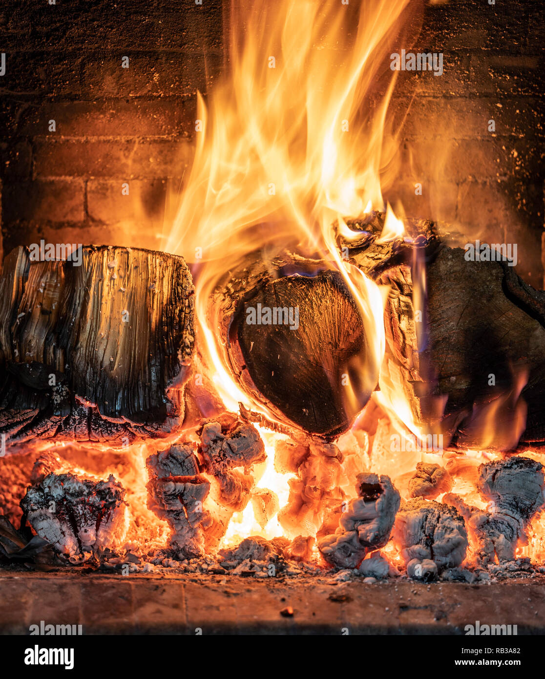 A blazing log fire in an open fireplace Stock Photo - Alamy