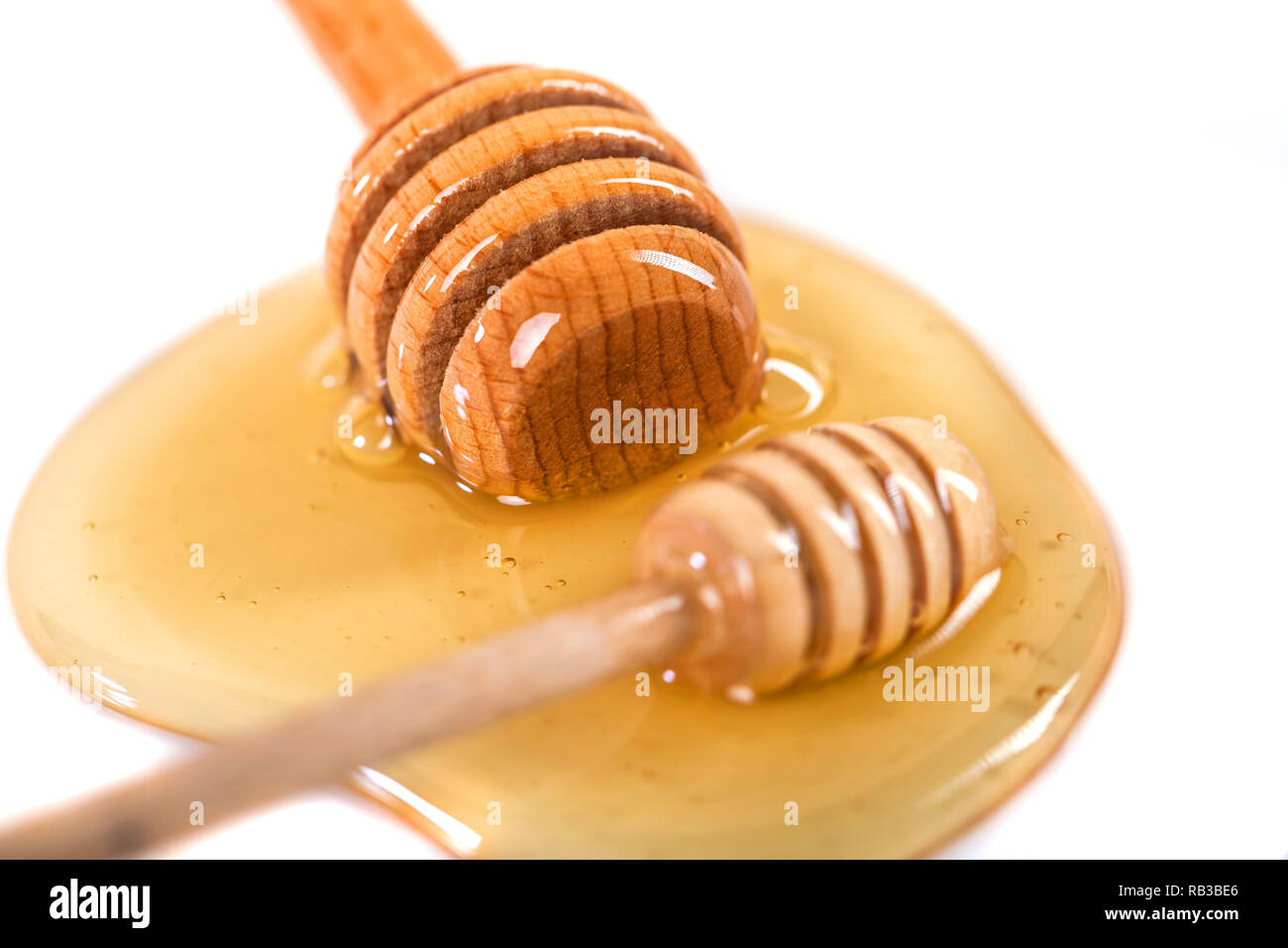 Honey with wooden dipper isolated on white background Stock Photo Alamy