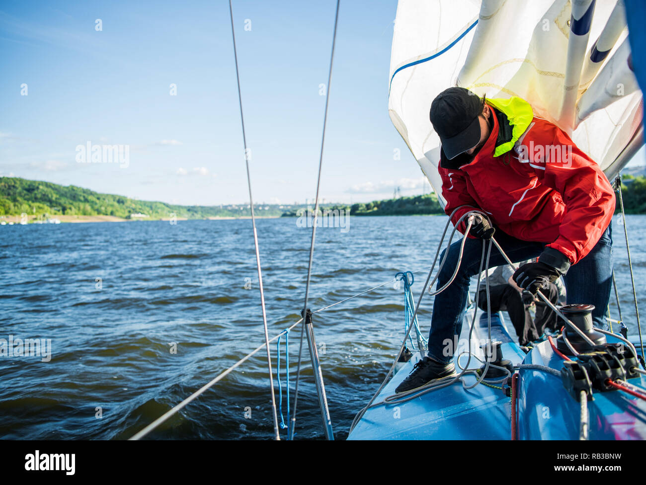 Young man working on sailing ship, active lifestyle, summer sport concept Stock Photo