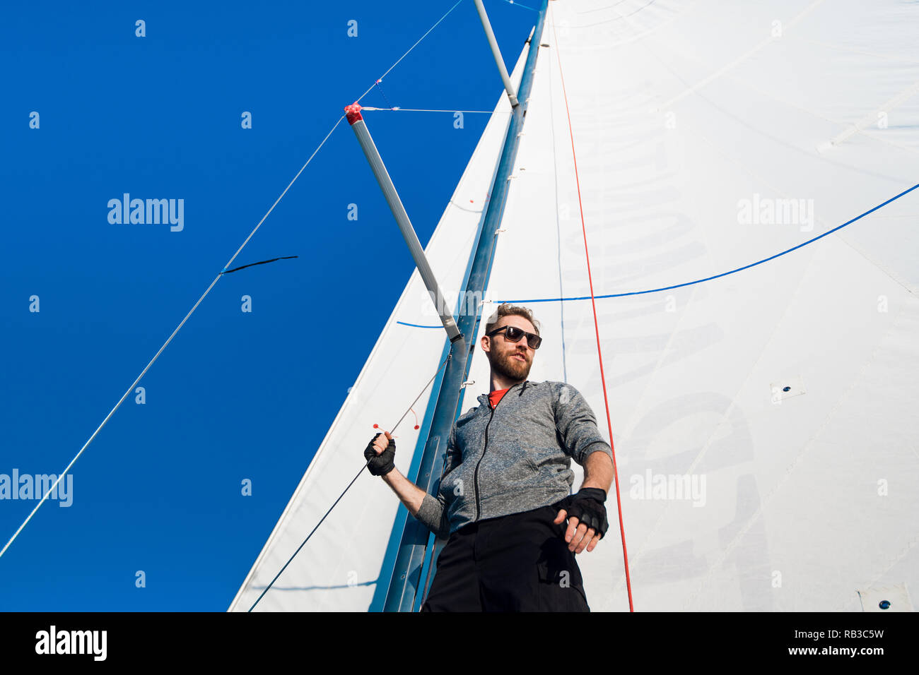 Young man steering boat hi-res stock photography and images - Alamy
