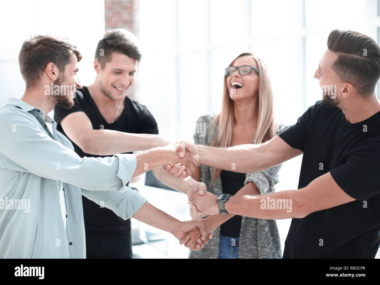 Happy smiling business team standing in a row at office Stock Photo - Alamy