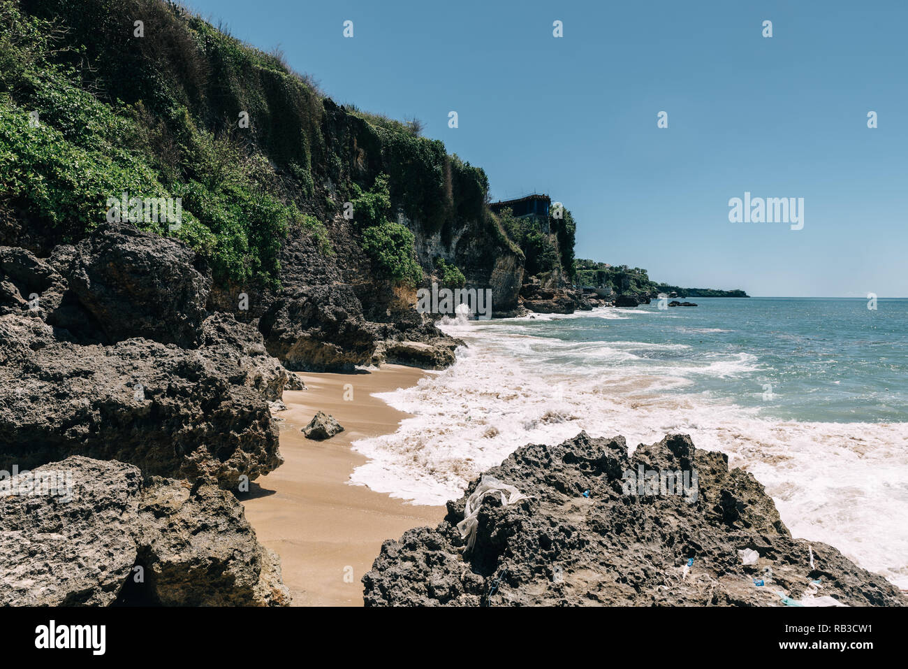 Beach On Bali Indonesia Called Pantai Tegal Wangi Sunny Clear Weather Big Cliffs With Houses Blue Sky And Ocean With Waves Rb3cw1 Jpg