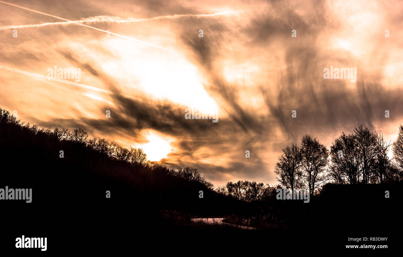 Sunset with dramatic sky with clouds and silhouettes of trees Stock ...