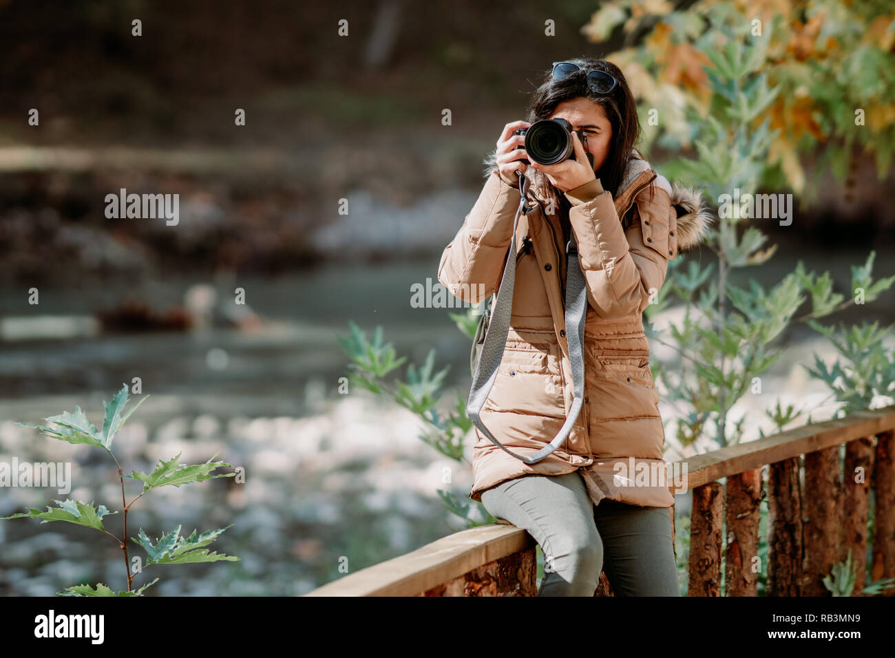 Nature Photographer taking pictures outdoors during trekking trip Stock Photo