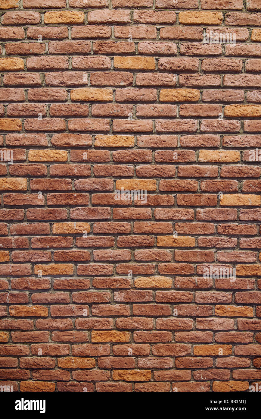 Vertical Red brick wall texture grunge background with vignetted corners. Stock Photo