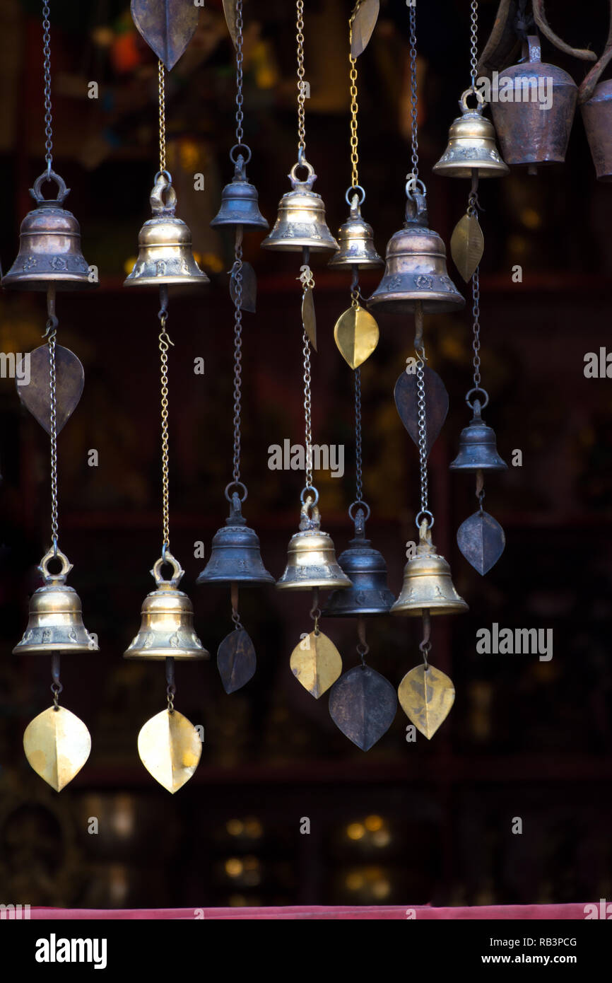 Chimes hanging in the window Decorative bells hang on the window behind with bokeh background The traditional wind bell fluttering in tropical wind in Stock Photo