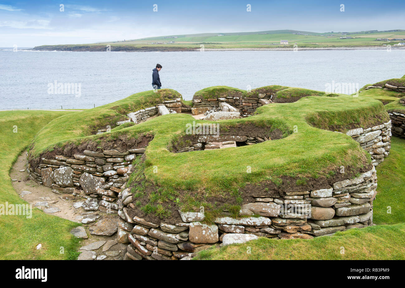 Tourists at Skara Brae, a stone-built Neolithic village located on the Bay of Skaill on the west coast of the Orkney Islands in Scotland. Stock Photo