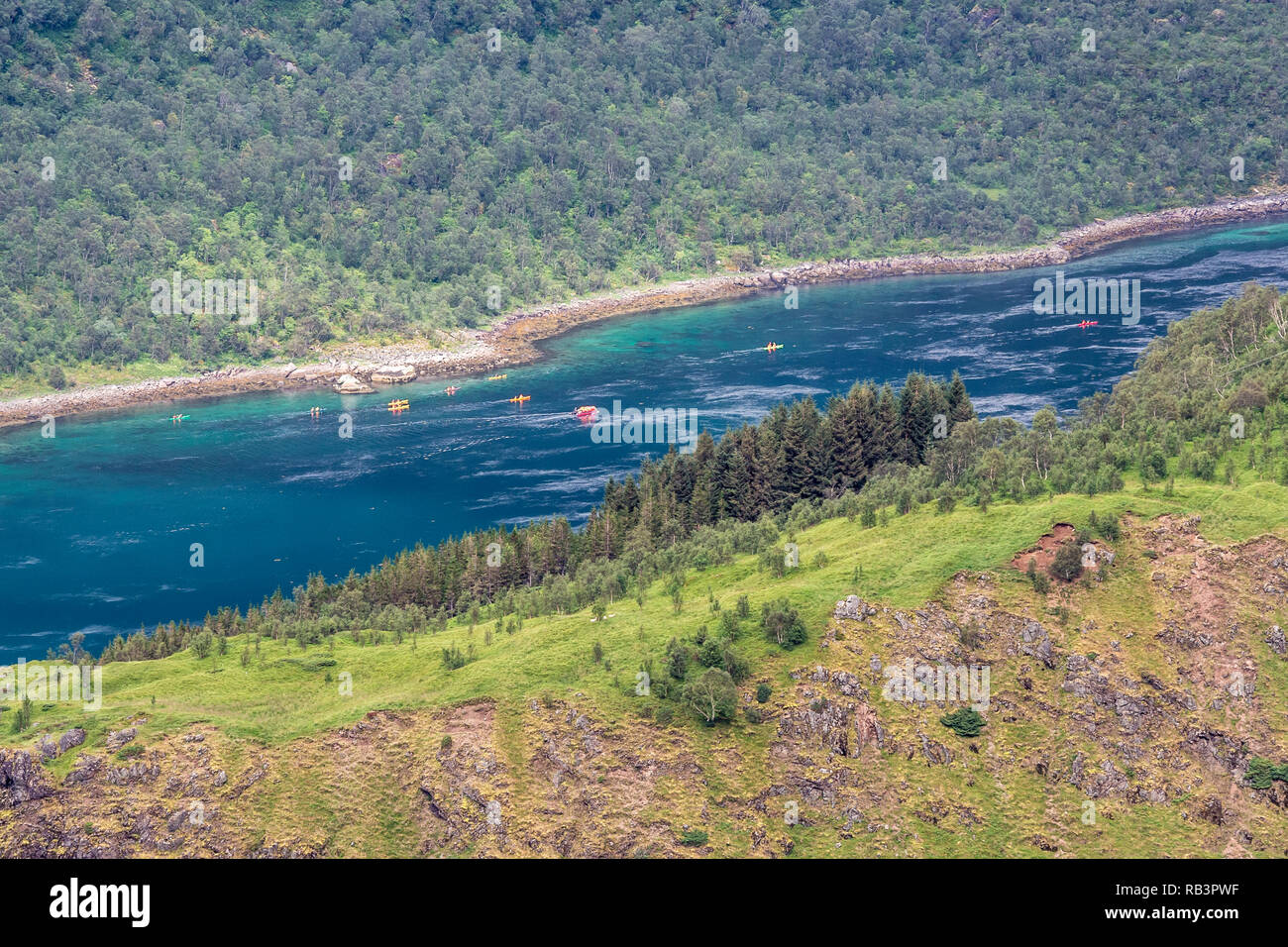 View from mountain range above village Raften down to shore at the Raftsund, the strait between islands  Hinnøya and Austvågøya, group of canoes, tour Stock Photo