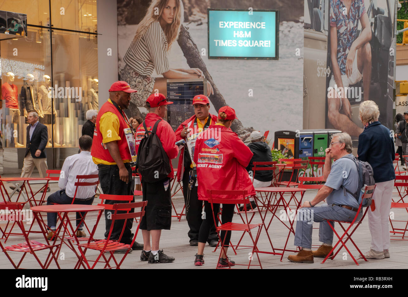 New York, NY, USA -- June 8, 2015. Workers gather for an impromptu meeting in a pedestrian plaza in midtown near Times Square. Stock Photo