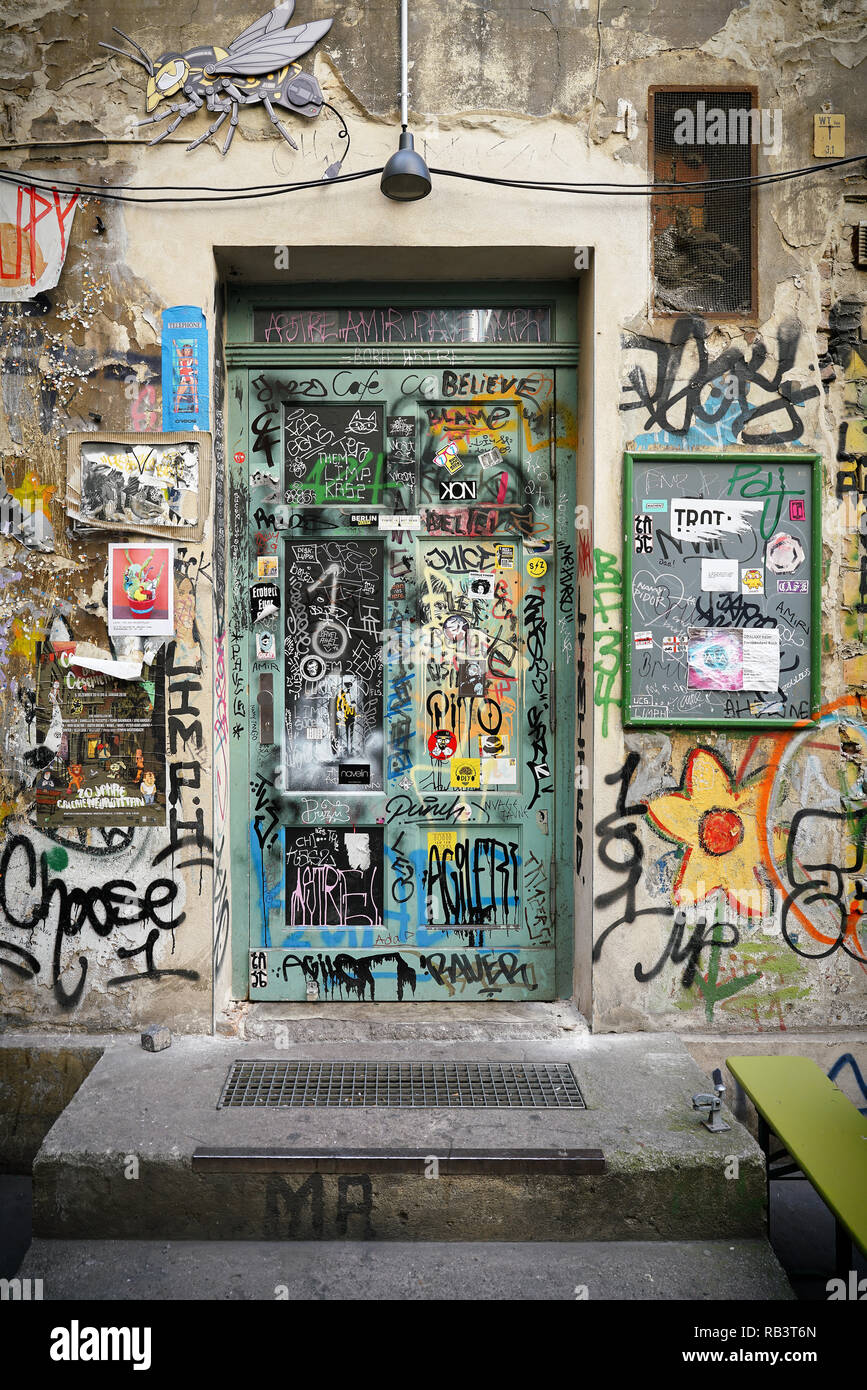 Streetart of several artists on the facade and the front door of a house in Berlin Stock Photo