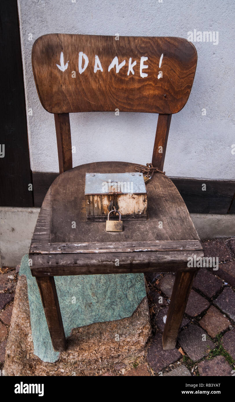Thanks For Wc Donate Secured Box On A Old Chair Stock Photo