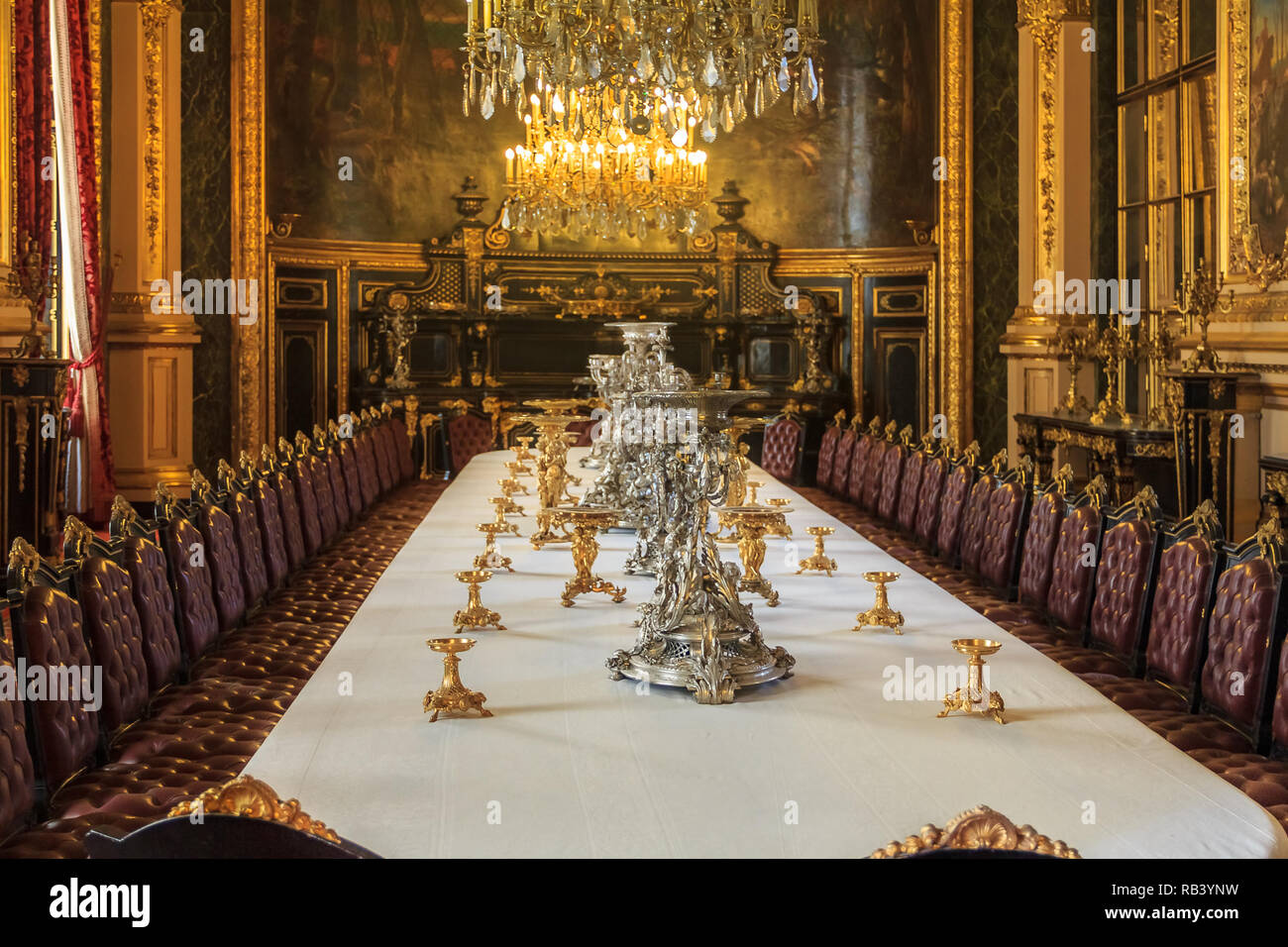 Paris, France - October 25, 2013: Banquet table in the apartments of Napoleon III in Louvre Museum with luxury baroque furnishings and stunning chande Stock Photo