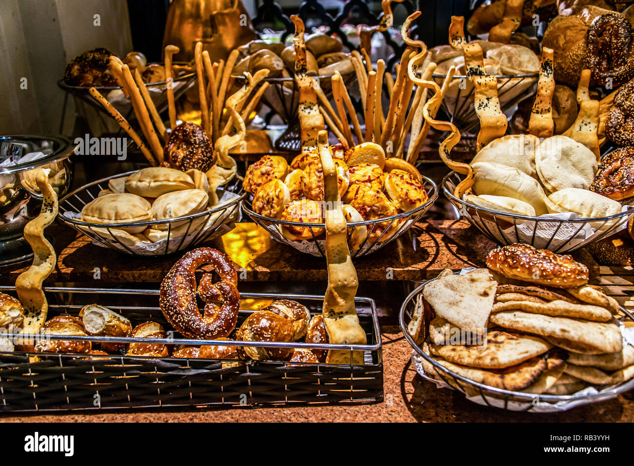 Bread bar station in buffet catering, close-up. Assortment of fresh pastry on table in restaurant. Pastry buffet set for breakfast in Egypt Stock Photo