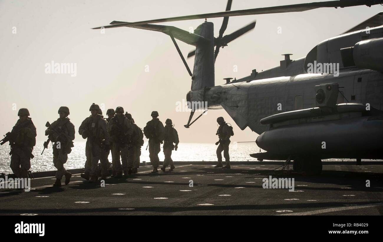 ARABIAN SEA - U.S. Marines with Lima Company, Battalion Landing Team 3/1, 13th Marine Expeditionary Unit (MEU), offload from a CH-53E Super Stallion with Marine Medium Tiltrotor Squadron 166 Reinforced, 13th MEU, aboard the Whidbey Island-class dock landing ship USS Rushmore (LSD 47), Jan. 5, 2019. The Essex Amphibious Ready Group and the 13th MEU are deployed to the U.S. 5th fleet area of operations in support of naval operations to ensure maritime stability and security in the Central Region, connecting the Mediterranean and the Pacific through the western Indian Ocean and three strategic ch Stock Photo