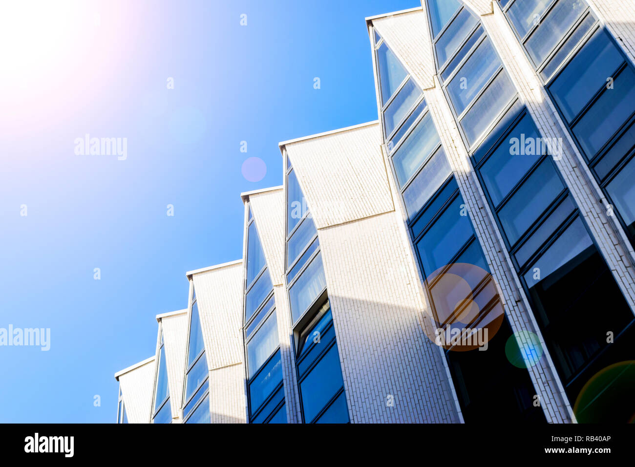 Details of office building exterior. Business buildings skyline looking up with blue sky. Modern architecture apartment. High tech exterior. Reflectiv Stock Photo