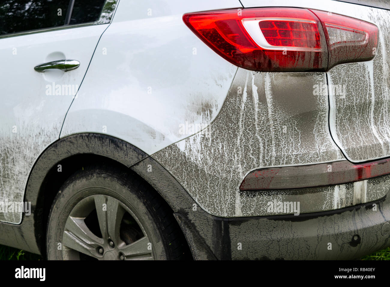 Back view of a very dirty car. Fragment of a dirty SUV. Dirty