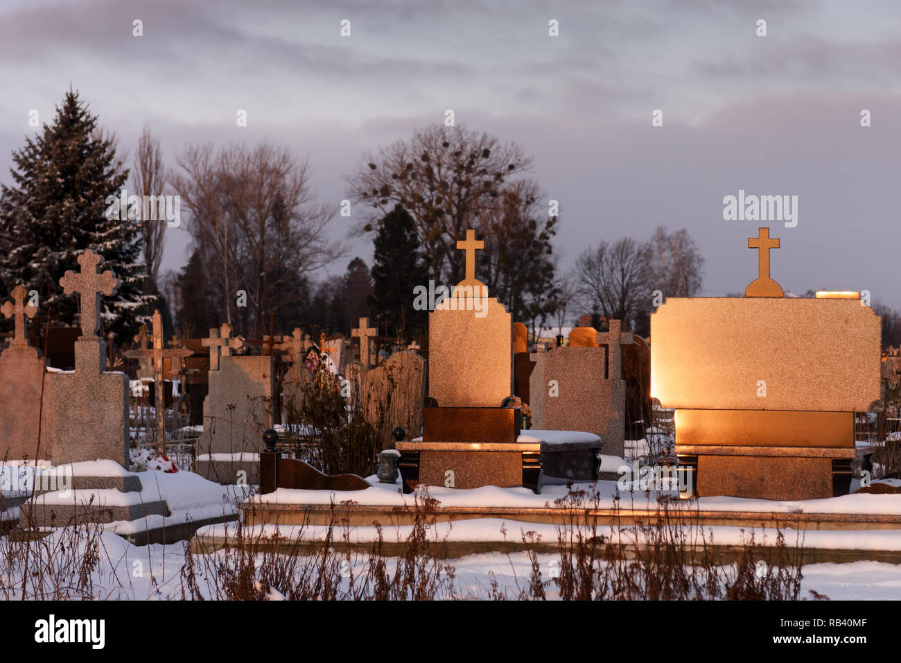 Cemetery with marble tombstone luminous on sunshine in evening time Stock Photo