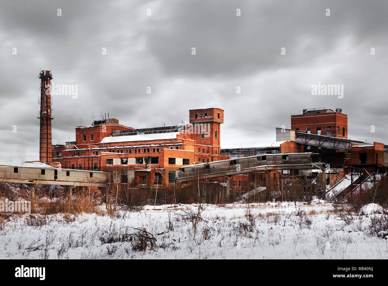 Old ruined factory construction in winter time. Urban exploration photography Stock Photo