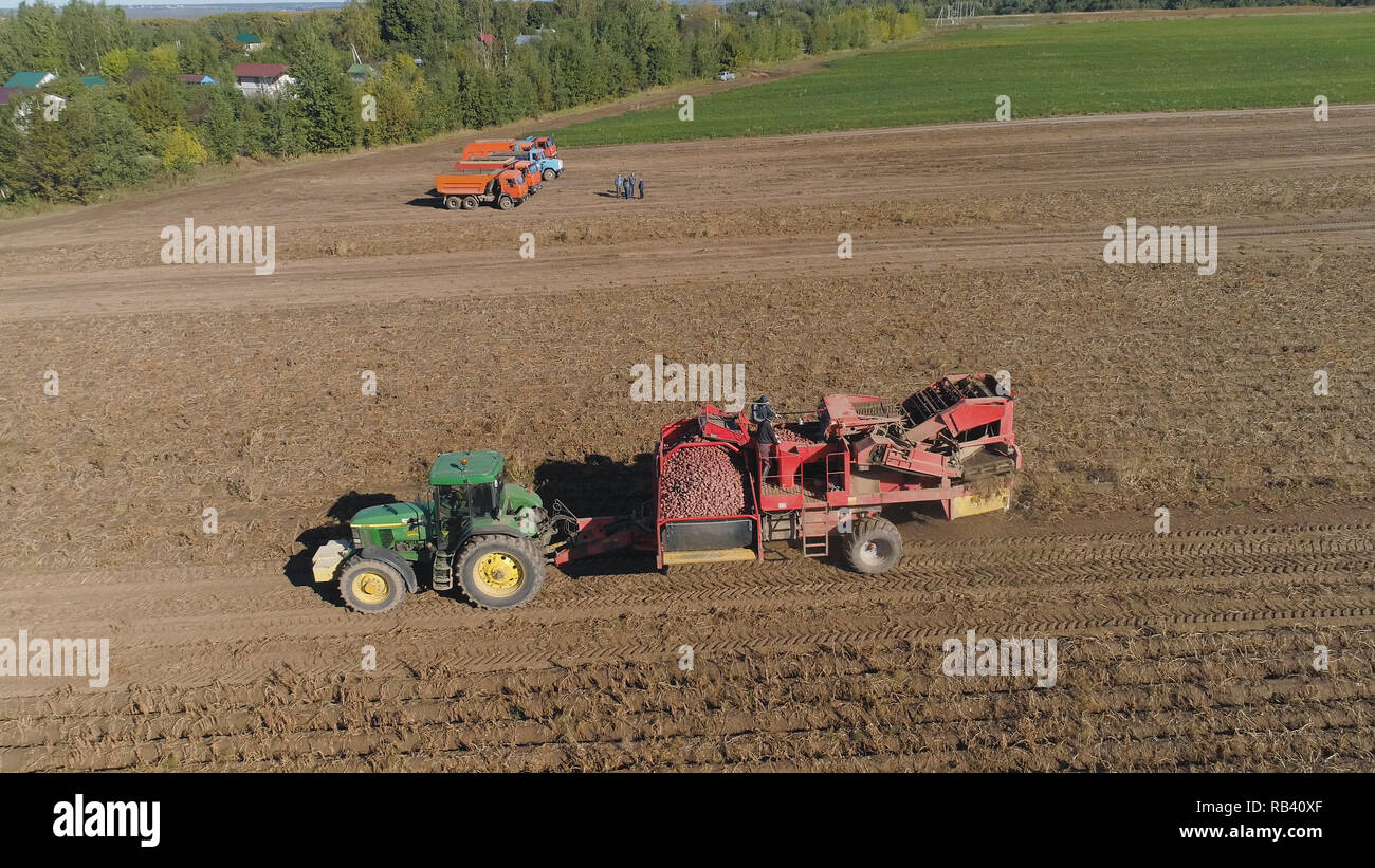potatoes harvesting machine with tractor in farm land for harvesting potatoes. Farm machinery