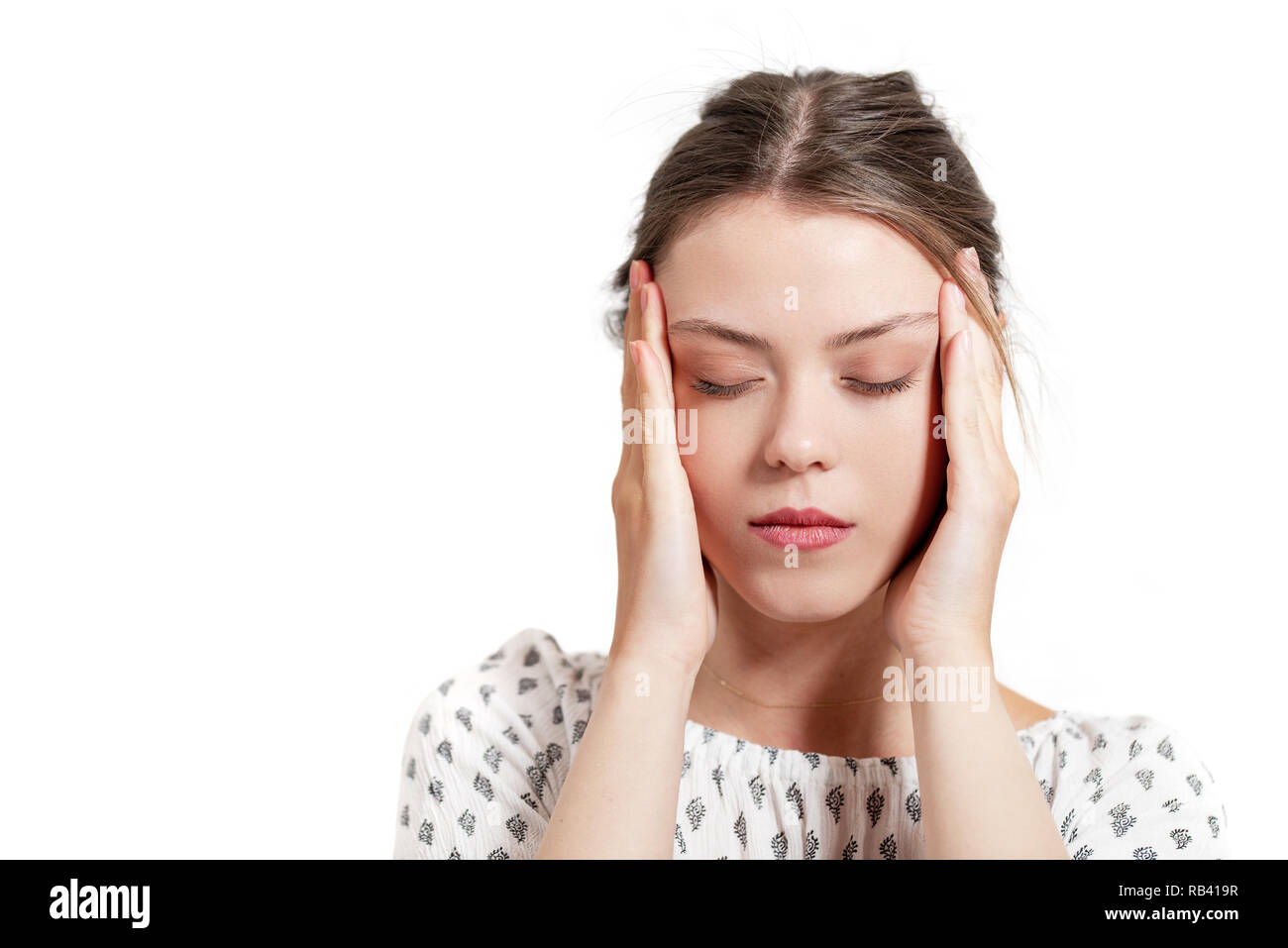 Beautiful young woman with headache touching her temples. Stock Photo