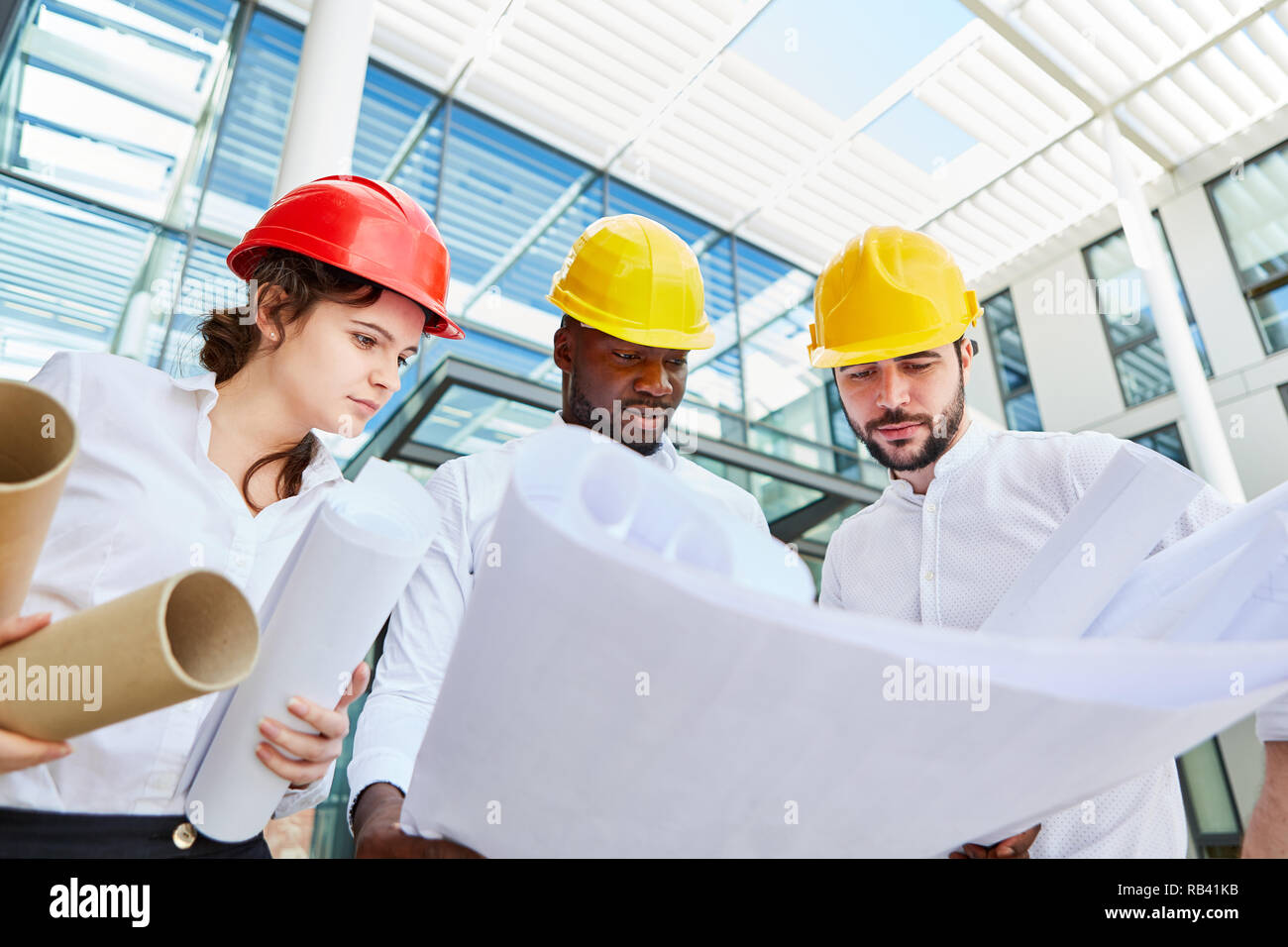 Architect team with blueprint makes project planning in urban planning Stock Photo