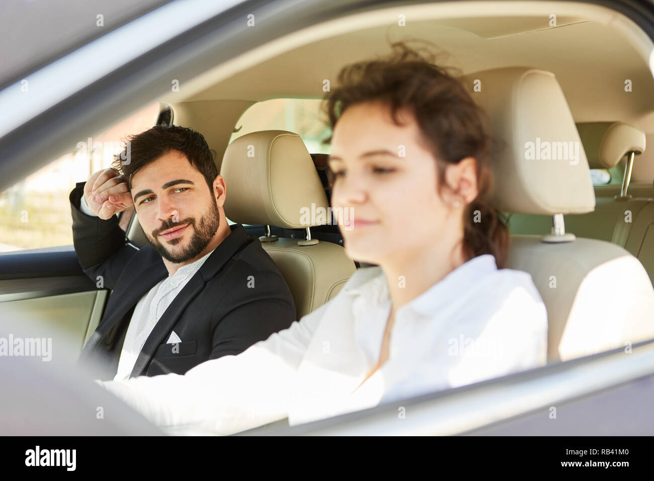 Young business couple on mission traveling together in the car Stock Photo