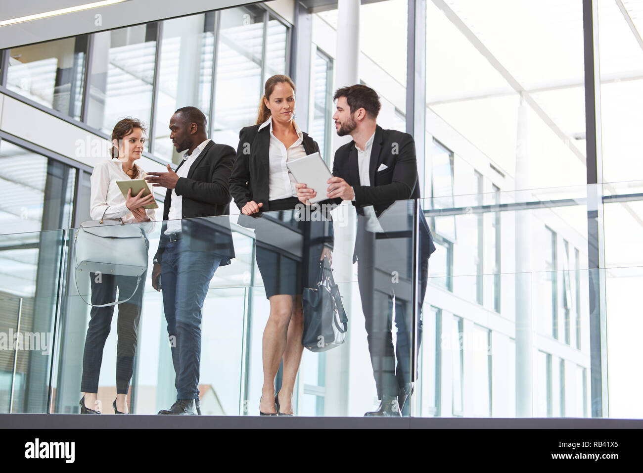 Successful business team talking in the modern office Stock Photo - Alamy