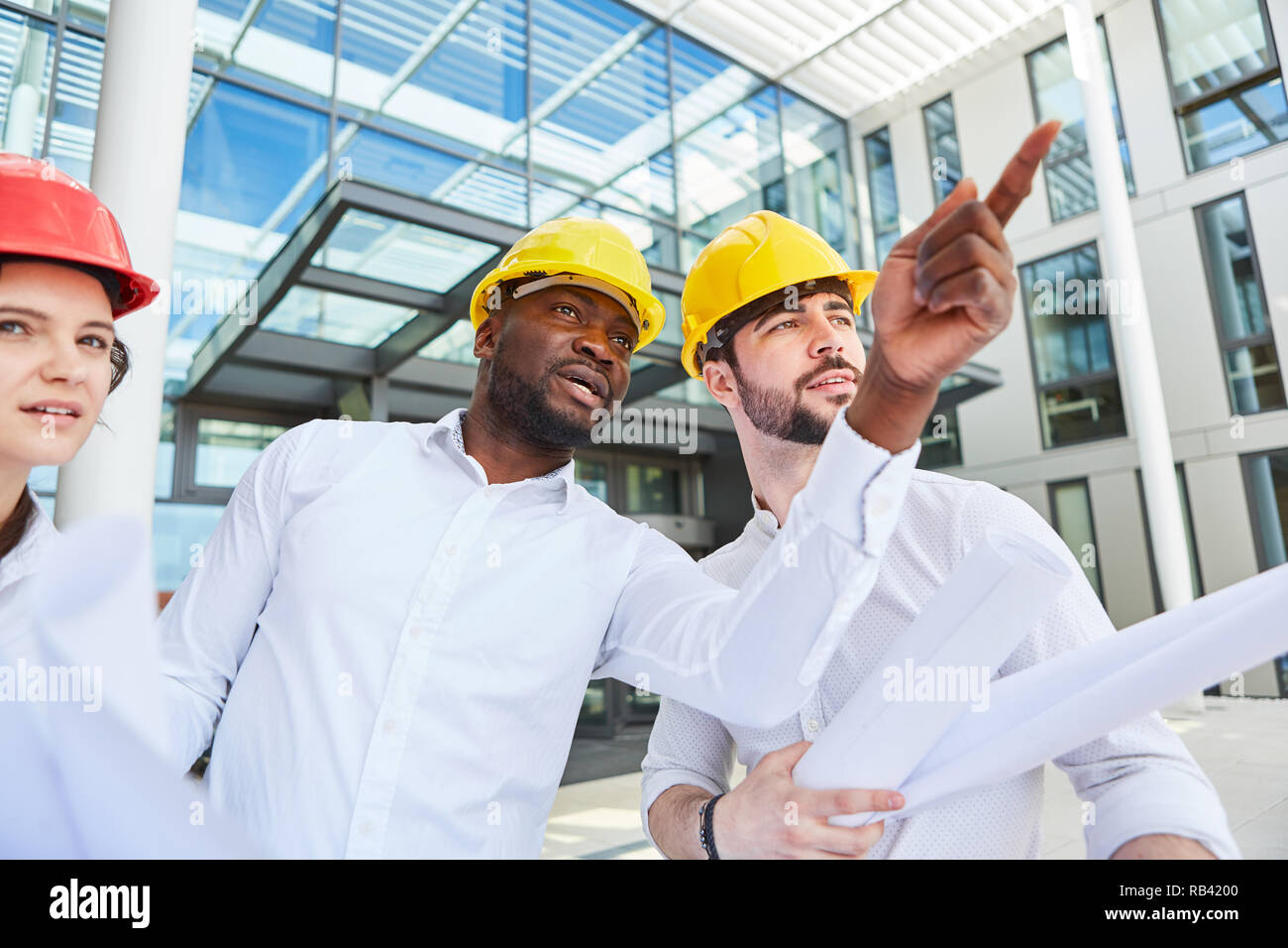 Site managers and architects team make a decision on a construction project Stock Photo